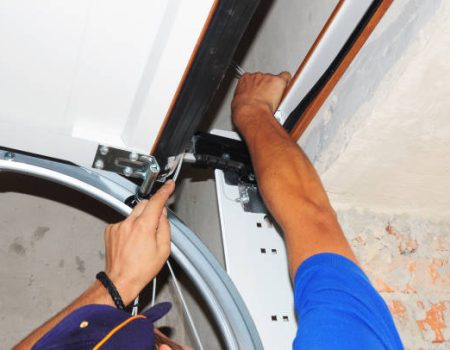 KYIV, UKRAINE - September 02, 2014:  Contractor repair garage door springs. Garage door seal, garage door springs, garage door replacement, garage door repair. Repair garage door opener.